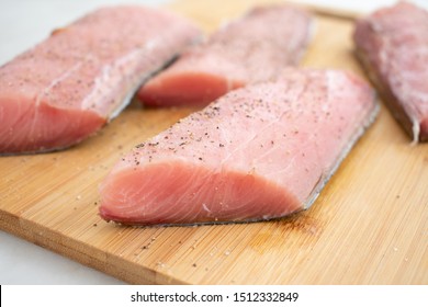 Raw Mahi Mahi (Dolphin Fish) Fillets on a Cutting Board