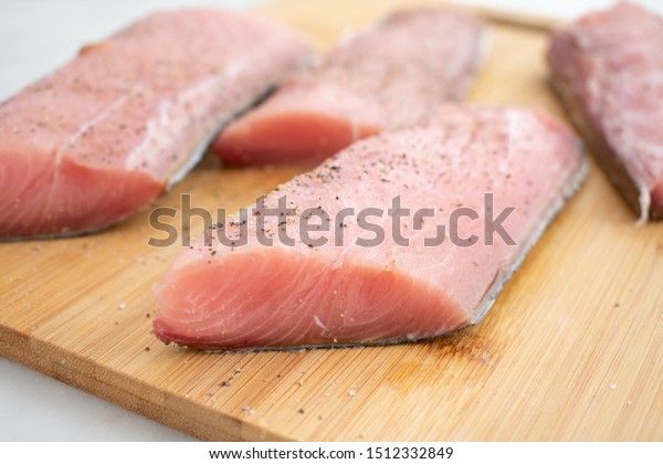 Raw\
Mahi Mahi (Dolphin Fish) Fillets on a Cutting\
Board