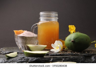 Raw Mango juice - Aam Panna or Panha in a transparent glass with whole green fruit,
