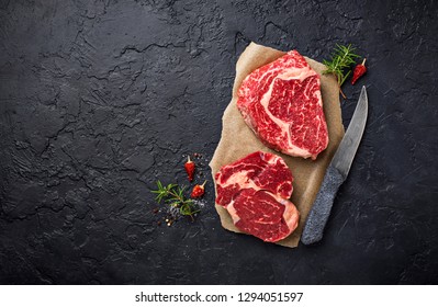 Raw Marbled Ribeye Steak. Fresh Meat And Spices. Top View