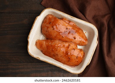 Raw marinated chicken fillets on wooden table, top view - Powered by Shutterstock