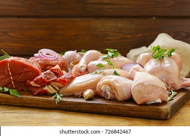 Raw Meat Assortment - Beef, Lamb, Chicken On A Wooden Board