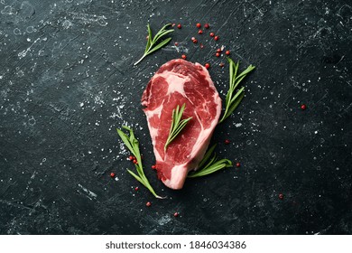 Raw meat, beef steak on dark background. Top view. Free space for your text. - Powered by Shutterstock