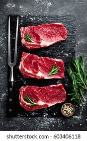 Raw meat, beef steak on black background, top view - Shutterstock ID 603406118