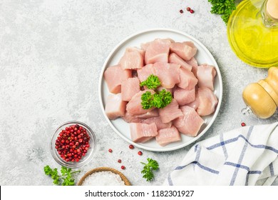 Raw meat cubes in a bowl with parsley, seasonings and olive oil. Top view, space for text. - Powered by Shutterstock