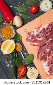 Raw Meat With Fresh Vegetables And Spices On Wooden Background. Top View. Free Space For Text. Prepare Yourself Concept