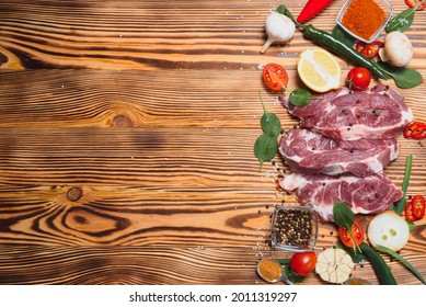 Raw Meat With Fresh Vegetables And Spices On Wooden Background. Top View. Free Space For Text. Prepare Yourself Concept