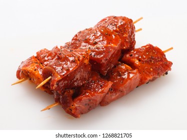 Raw meat on skewers in marinade with vegetables and spices. - Powered by Shutterstock