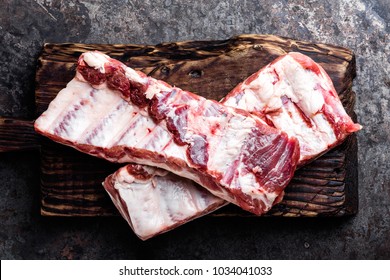 raw meat ribs on wooden cutting board