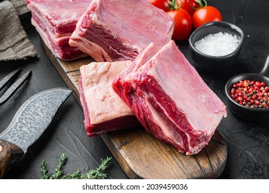 Raw meat ribs set, with ingredients, on black stone background