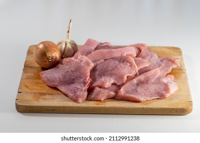 Raw Meat. Sliced Turkey Breasts Are On A Wooden Board.