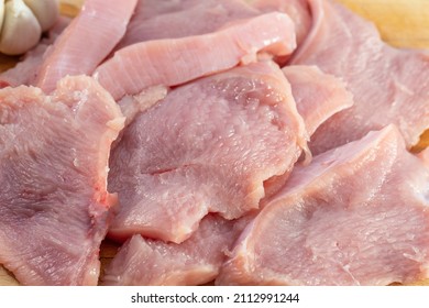 Raw Meat. Sliced Turkey Breasts Are On A Wooden Board.