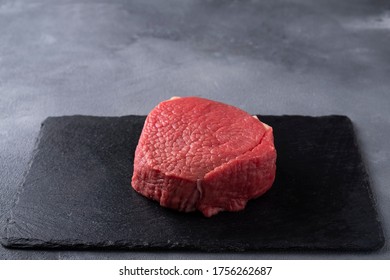 Raw meat steak on black stone board. Pork tenderloin. Space for text - Shutterstock ID 1756262687