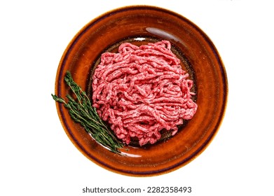 Raw mince angus wagyu beef, ground meat with herbs on a plate. Isolated on white background
