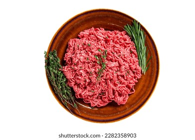 Raw mince beef and lamb meat on a rustic plate with herbs. Isolated on white background