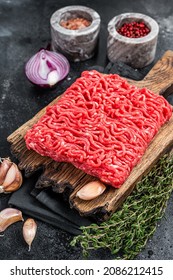 Raw Mince, Minced Ground Beef Meat On A Cutting Board. Black Background. Top View