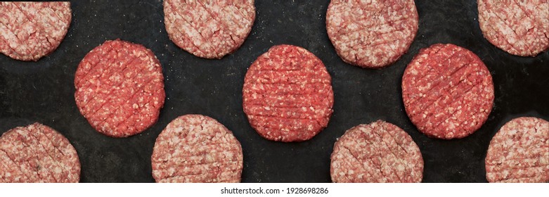 Raw Minced Steak Burgers From Beef And Pork Meat On Black Background, Overhead View. Raw Ground Beef, Round Patties For Cooking Homemade Burger On BBQ Grill, Top View