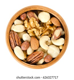 Raw Mixed Nuts In Wooden Bowl. Dried Walnuts, Hazelnuts, Almonds, Cashews, Macadamia, Brazil And Pecan Nuts. Fancy Mix Of Snack Food. Isolated Macro Food Photo Close Up From Above On White Background.