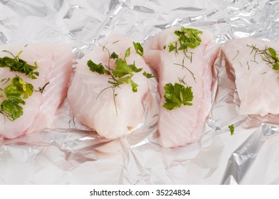 Raw Monk Fish With Herbs On Tin Foil