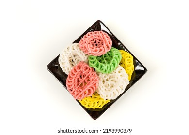 Raw Multicolored Tapioca Crackers On A Ceramic Plate Top Down Isolated Over White