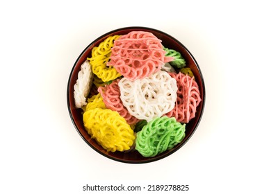 Raw Multicolored Tapioca Crackers In An Orange Bowl Top Down Isolated Over White