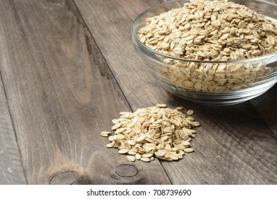 Raw Oats Or Flakes On Wooden Background