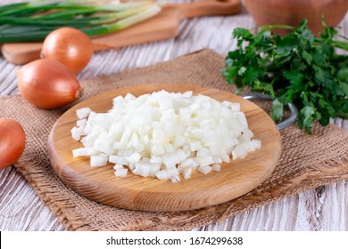 Raw onion, chopped very small cubes on a wooden board