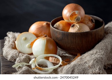 Raw onions, in a composition on an old background