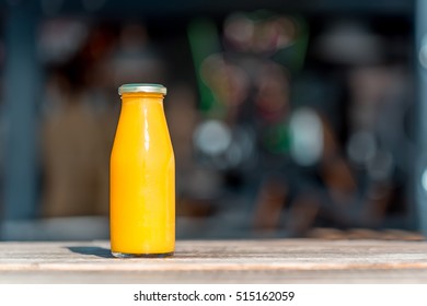 Raw orange juice in glass bottle