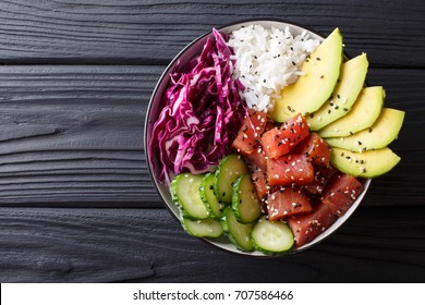 Raw Organic Ahi Tuna Poke Bowl with Rice and Veggies close-up on the table. Top view from above horizontal - Shutterstock ID 707586466