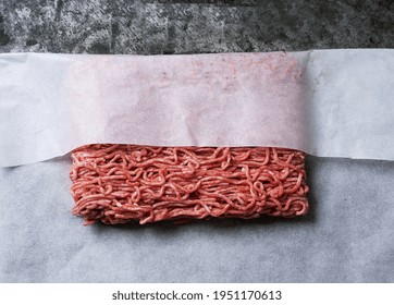 Raw Organic Beef Mince Meat In White Paper Wrap. Top View. Flat Lay.