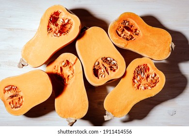 Raw Organic Butternut Squash Ready To Cook On White Wooden Background Viewed From Above, Plant Based Food, Harsh Shadows