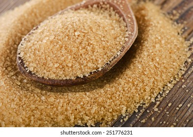 Raw Organic Cane Sugar In A Wooden Spoon. Selective Focus