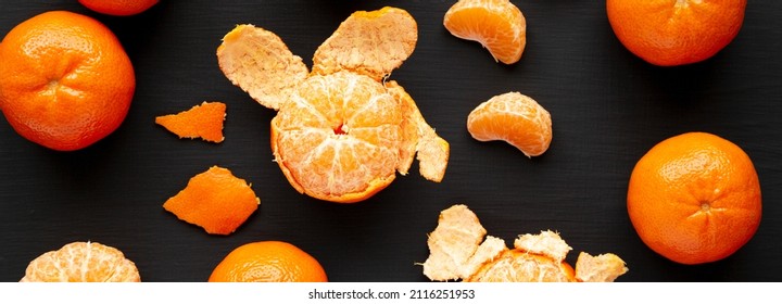 Raw Organic Mandarin Oranges On A Black Background, Top View. Flat Lay, Overhead, From Above.