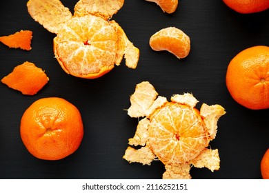 Raw Organic Mandarin Oranges On A Black Background, Top View. Flat Lay, Overhead, From Above.