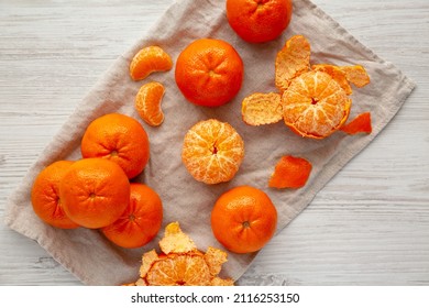 Raw Organic Mandarin Oranges On A White Wooden Background, Top View. Flat Lay, Overhead, From Above.