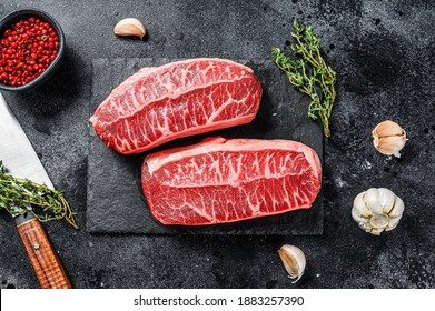 Raw Organic Meat Twagyu Oyster Top Blade Steak. Black Background. Top View