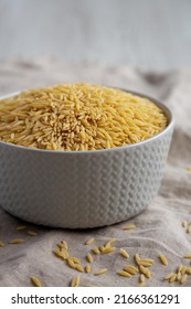 Raw Organic Risoni Pasta In A Bowl, Side View. 