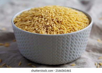 Raw Organic Risoni Pasta In A Bowl, Side View. Close-up.