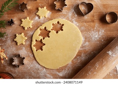 Raw pastry dough from which star shapes are being cut out, top view - Powered by Shutterstock