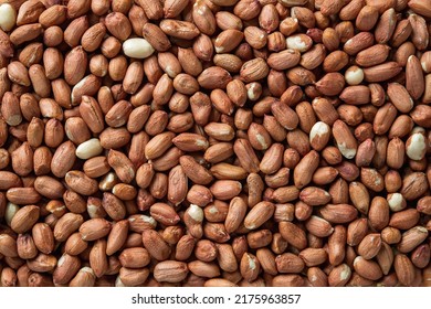 Raw peeled peanut background. Texture of dried groundnut seeds. Whole organic monkey nut without shell. Arachis hypogaea kernels for dietary nutrition. Healhy vegetarian snack. Top view.
