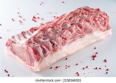 raw pork brisket on the rib, pork brisket on a bone. A piece of raw meat on a white background.