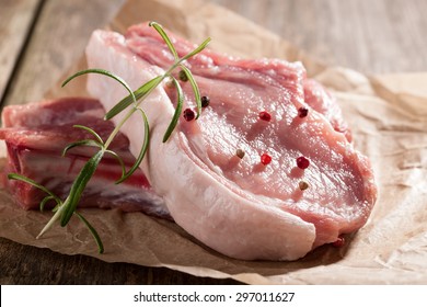 Raw Pork Chop On Wooden Table