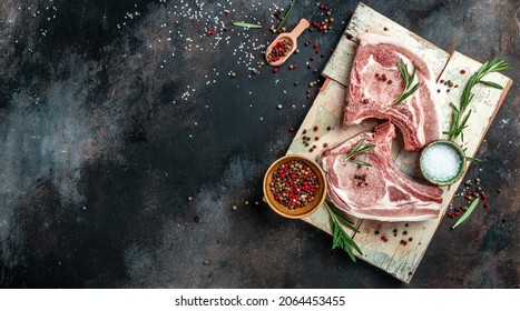 Raw Pork Chop Steak With Spices And Rosemary. Pork, Beef, Chop On A Bone. Top View. Place For Text.