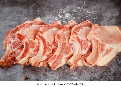 Raw Pork Chops Bone In Isolated On Grey Background. Close Up.