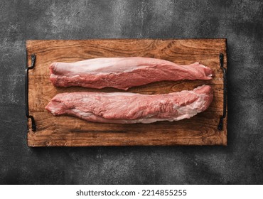 Raw Pork Fillet Tenderloin On Wooden Board Top View. Filet Mignon Of Raw Pork.