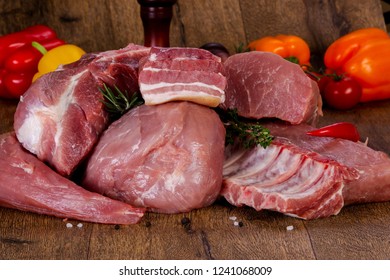 Raw pork meat over wooden background - Shutterstock ID 1241068009