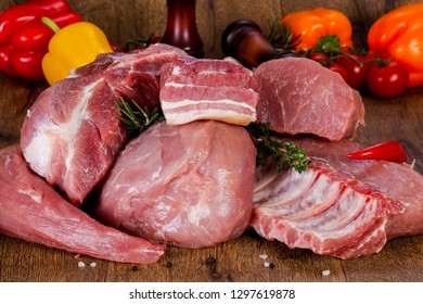 Raw pork meat over wooden background - Shutterstock ID 1297619878