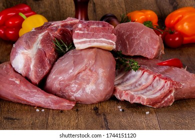 Raw pork meat over wooden background - Shutterstock ID 1744151120