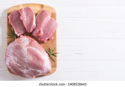 Raw pork meat . Shoulder and fillet on wooden background